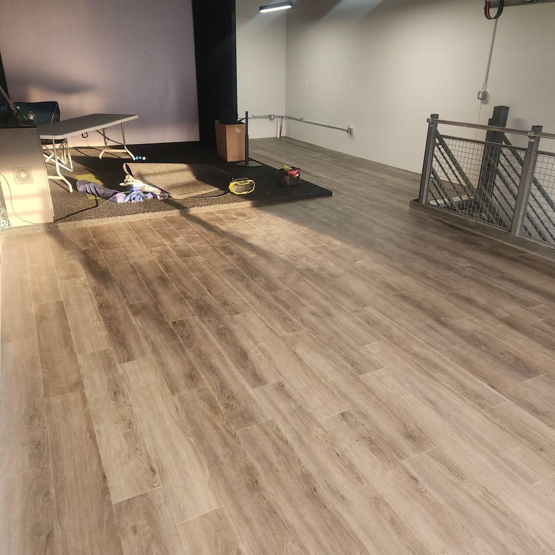 A large open commercial room in plank flooring