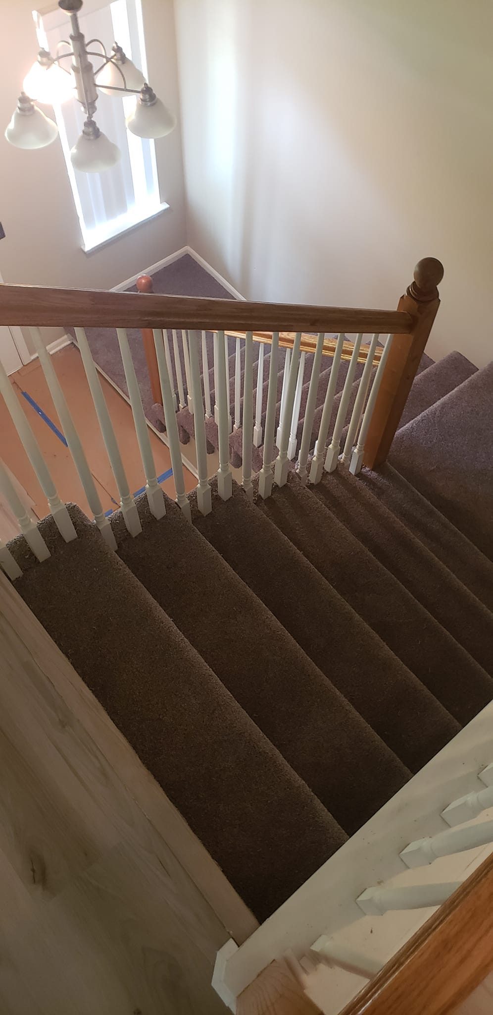 A carpeted stair and landing seen from above