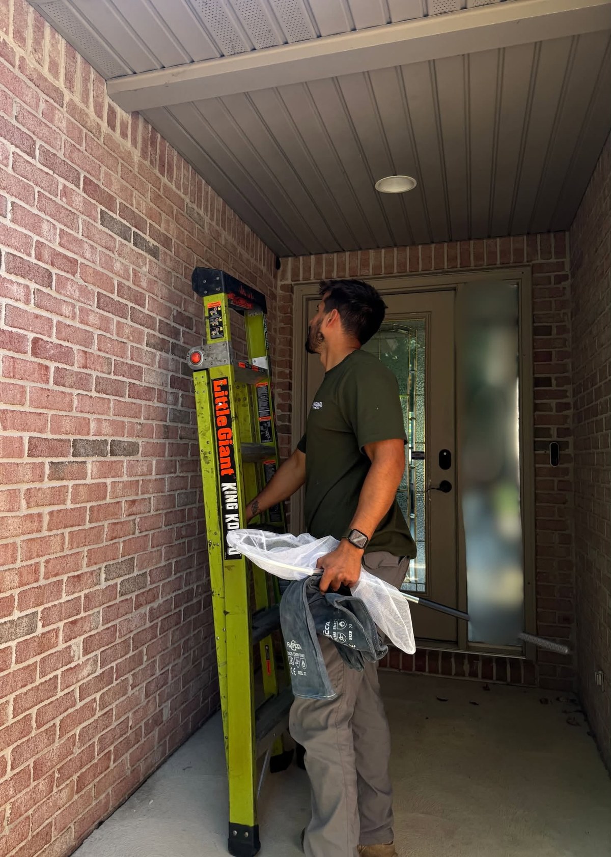 Nick at a front porch with a Little Giant ladder, unpacking supplies