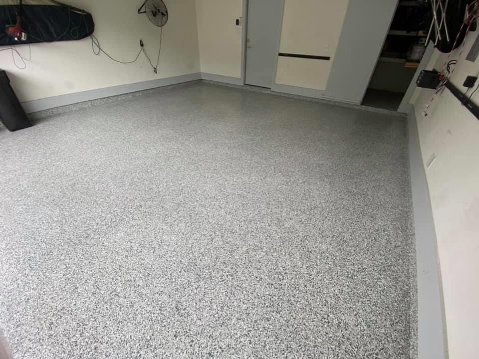 A two car garage with a flake epoxy floor