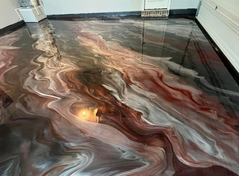 A copper and grey metallic epoxy floor