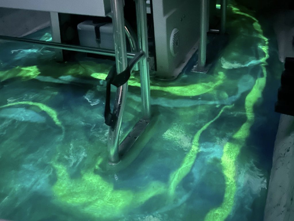A glowing green metallic epoxy floor