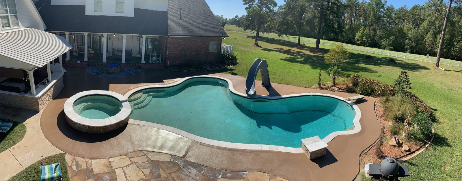 A coated pool deck around a freeform pool