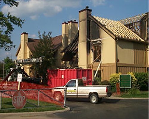 A fire-damaged roof being rebuilt