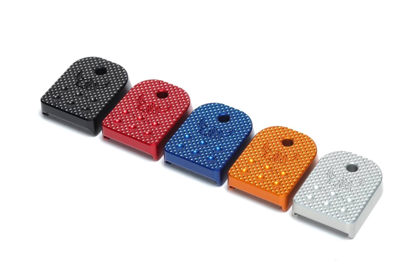 Black, red, blue, orange and silver checkered Henning base pads in a row