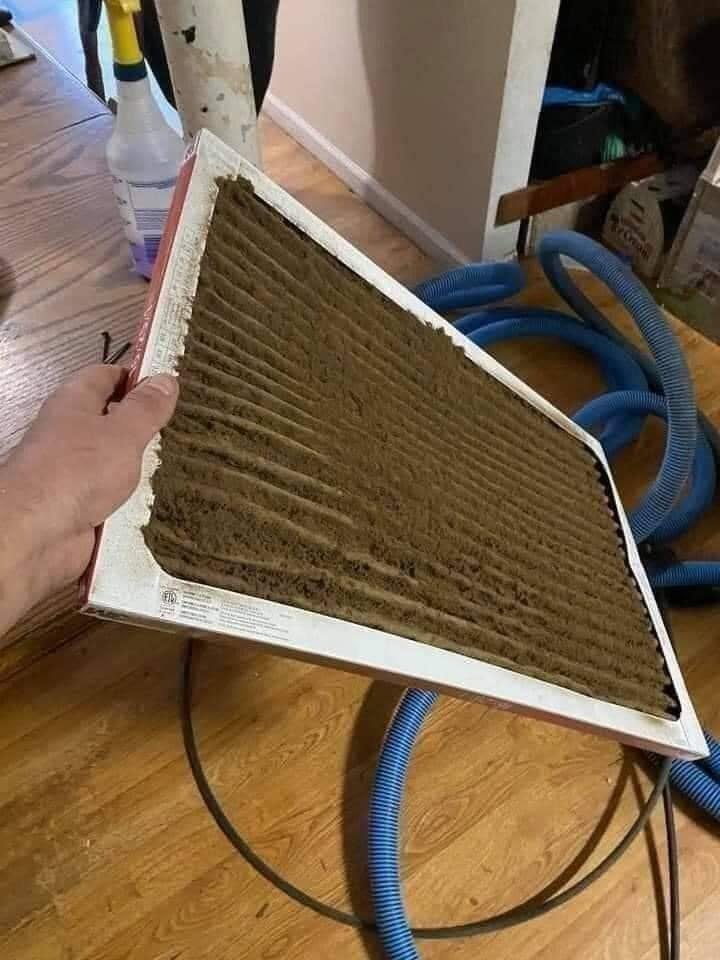 A heavily loaded furnace filter pulled from a customer's system