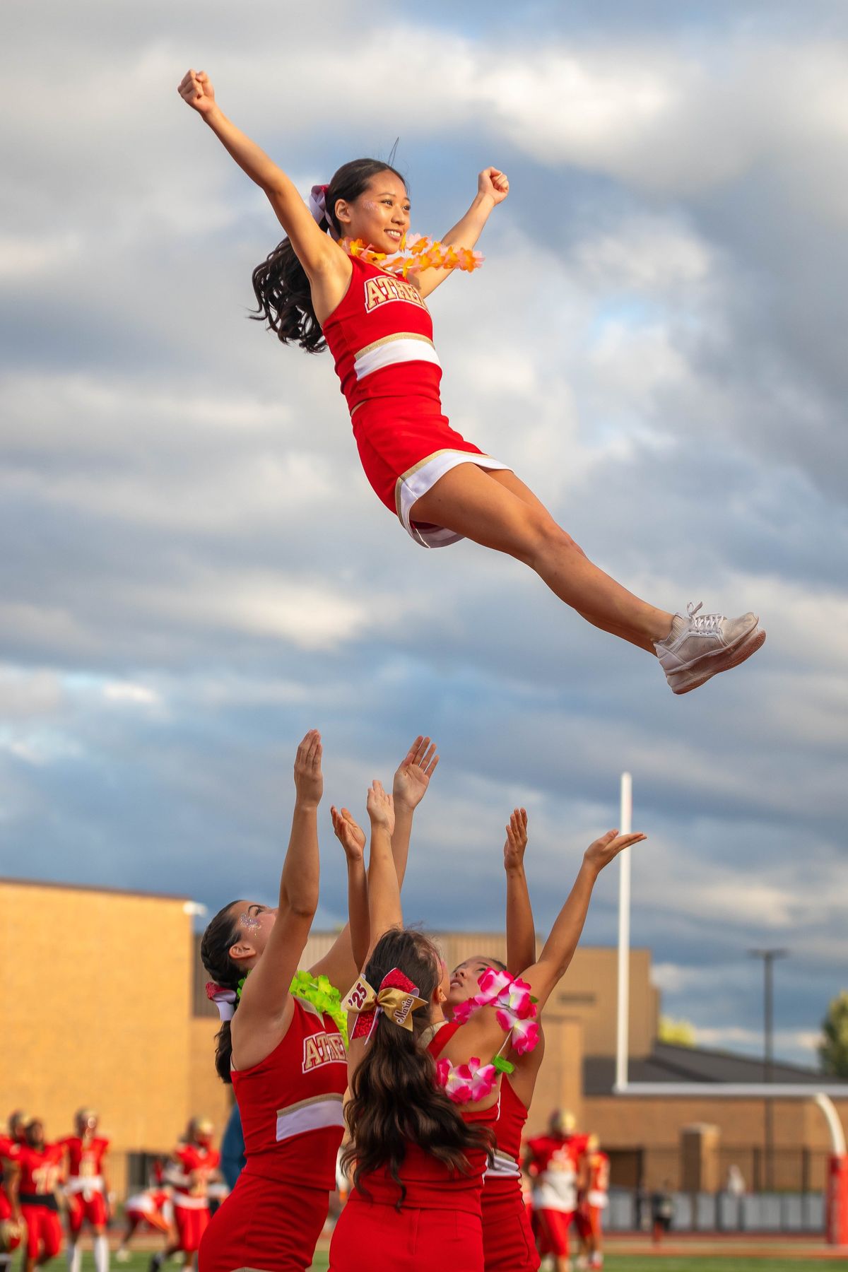 A cheer flyer high above the squad