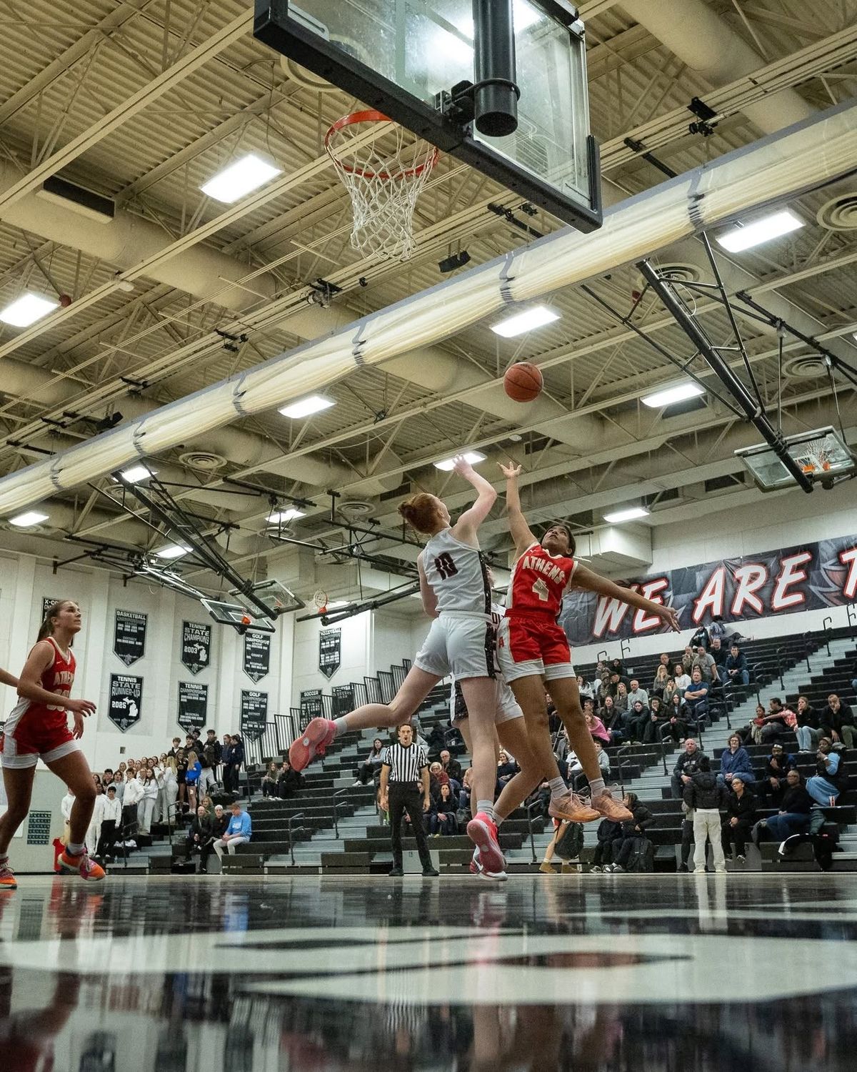 A basketball layup in a packed gym