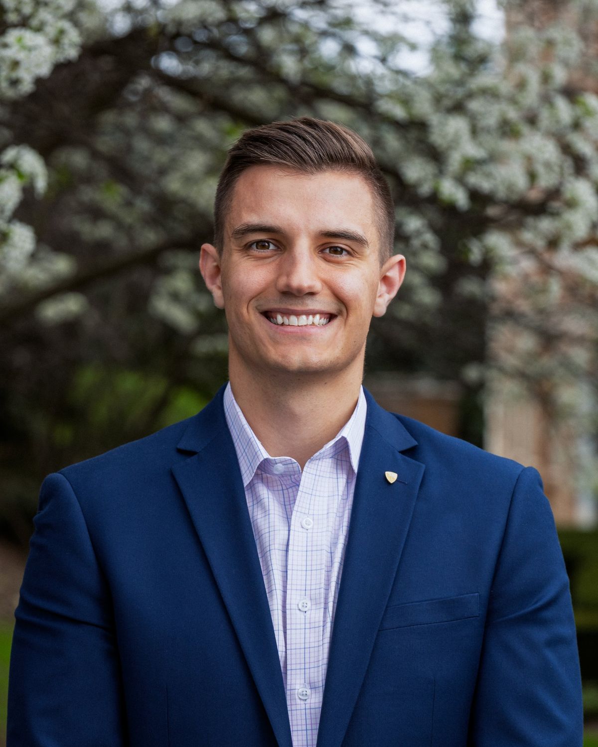 A business headshot in a navy suit