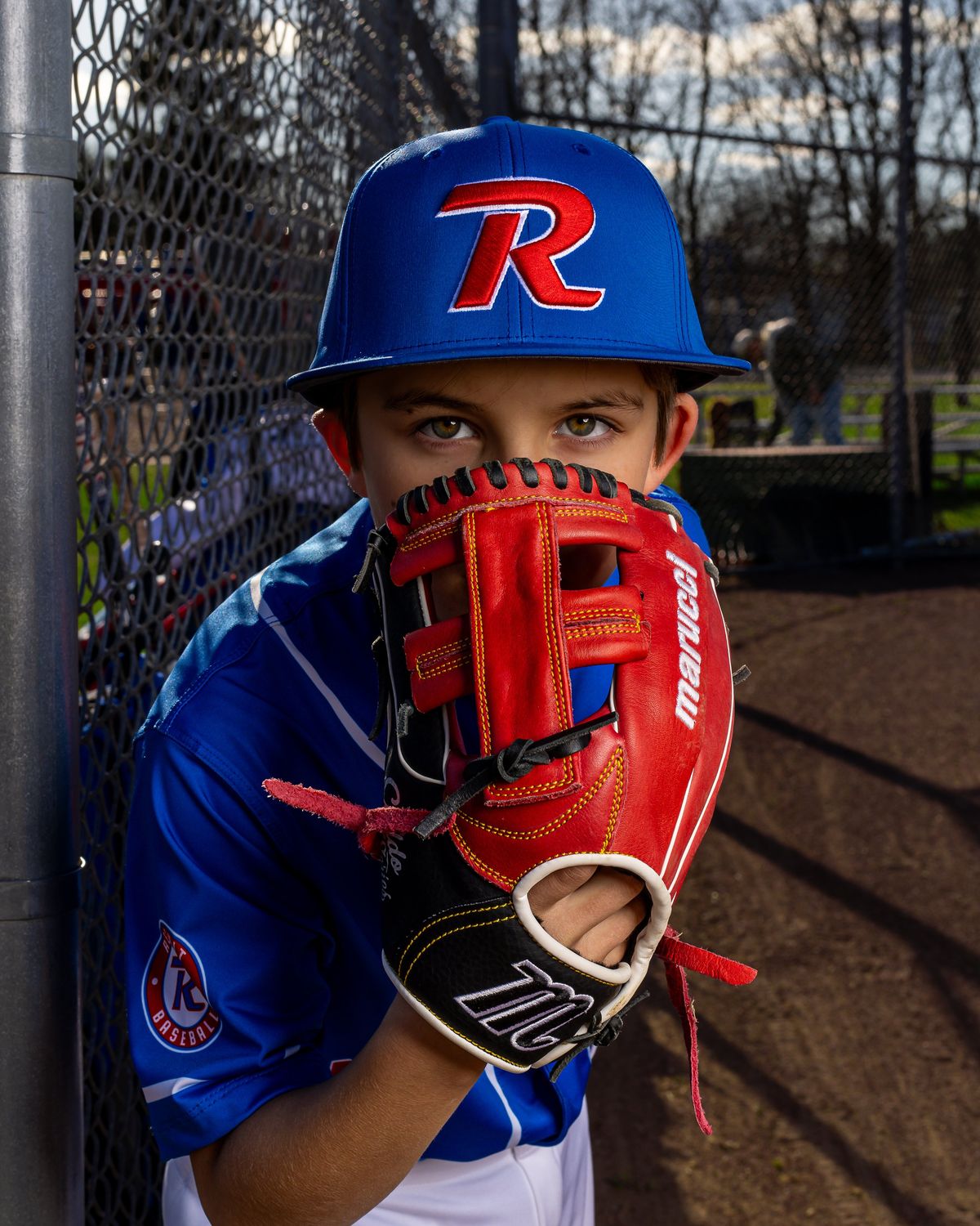 A young catcher behind his glove