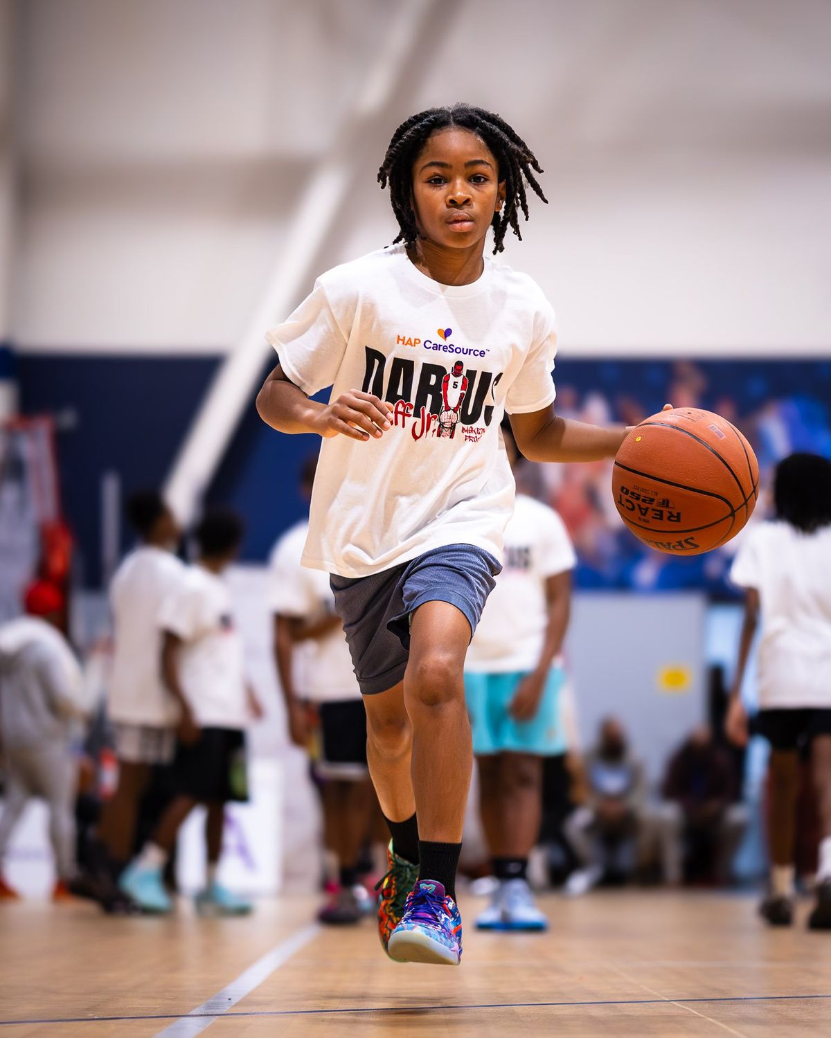 A young basketball player bringing the ball up