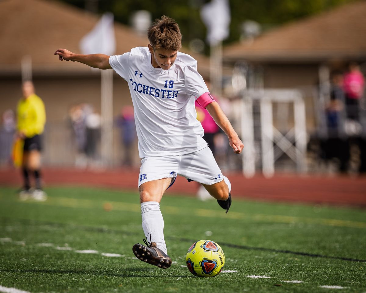 A soccer player following through on a kick
