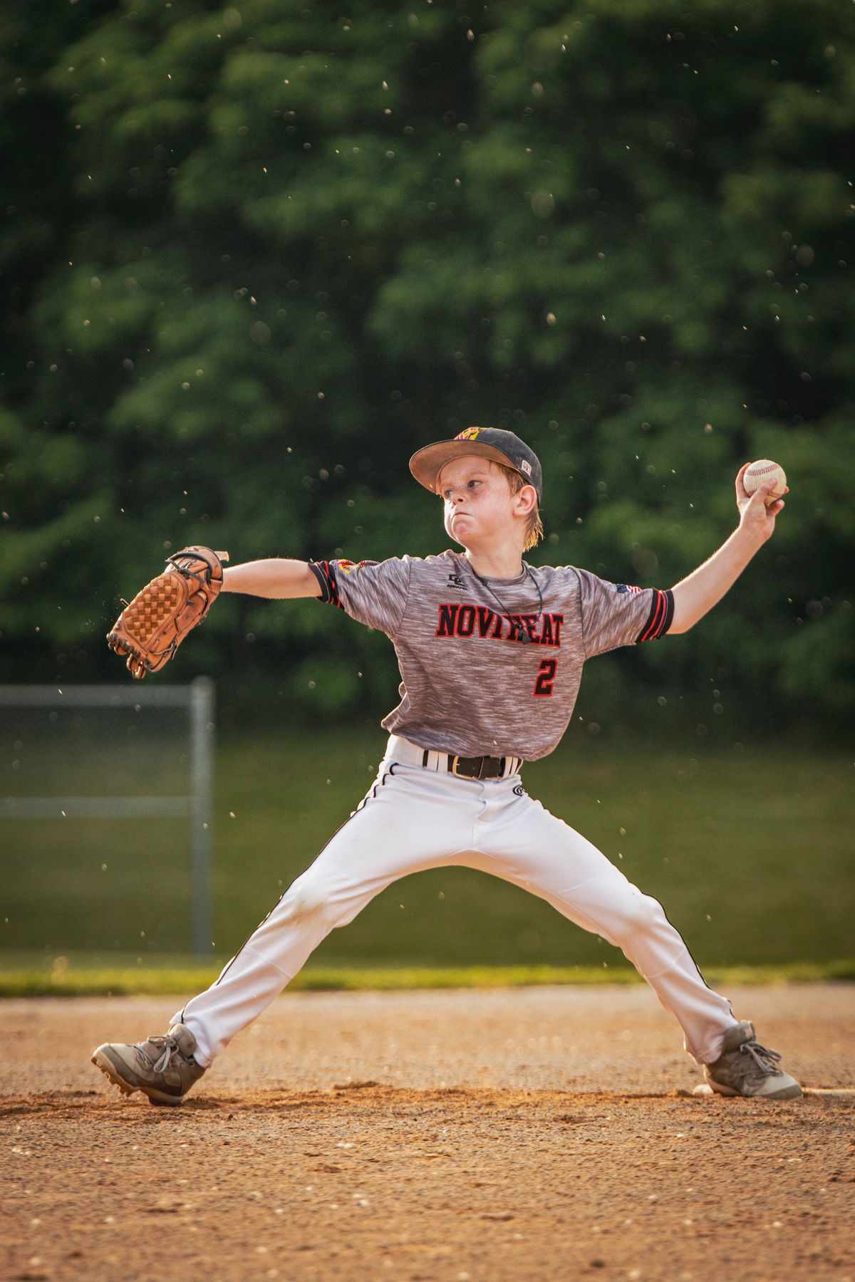 A youth pitcher mid-delivery