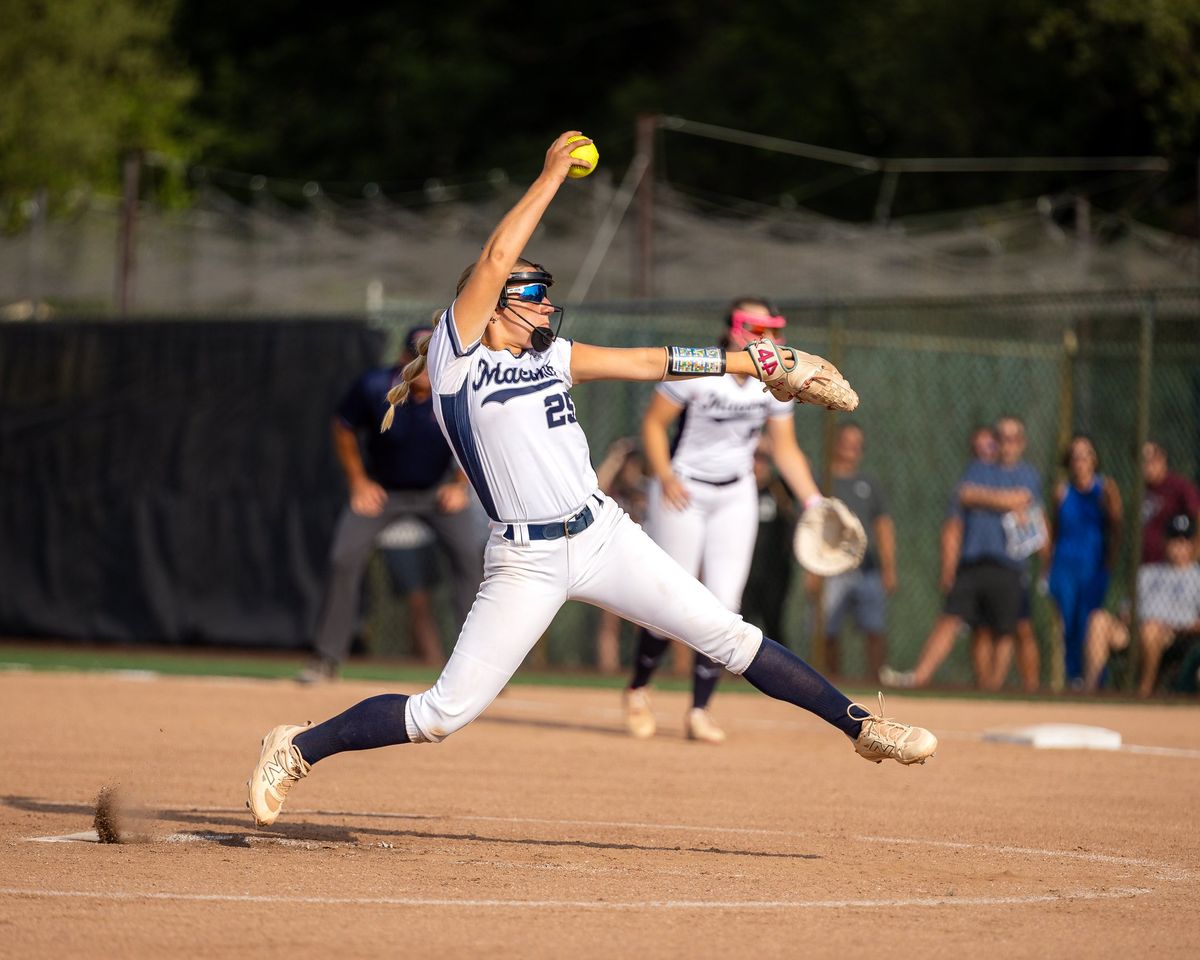 A softball pitcher in a stadium