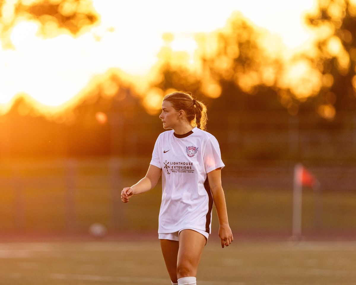 A soccer player in golden light