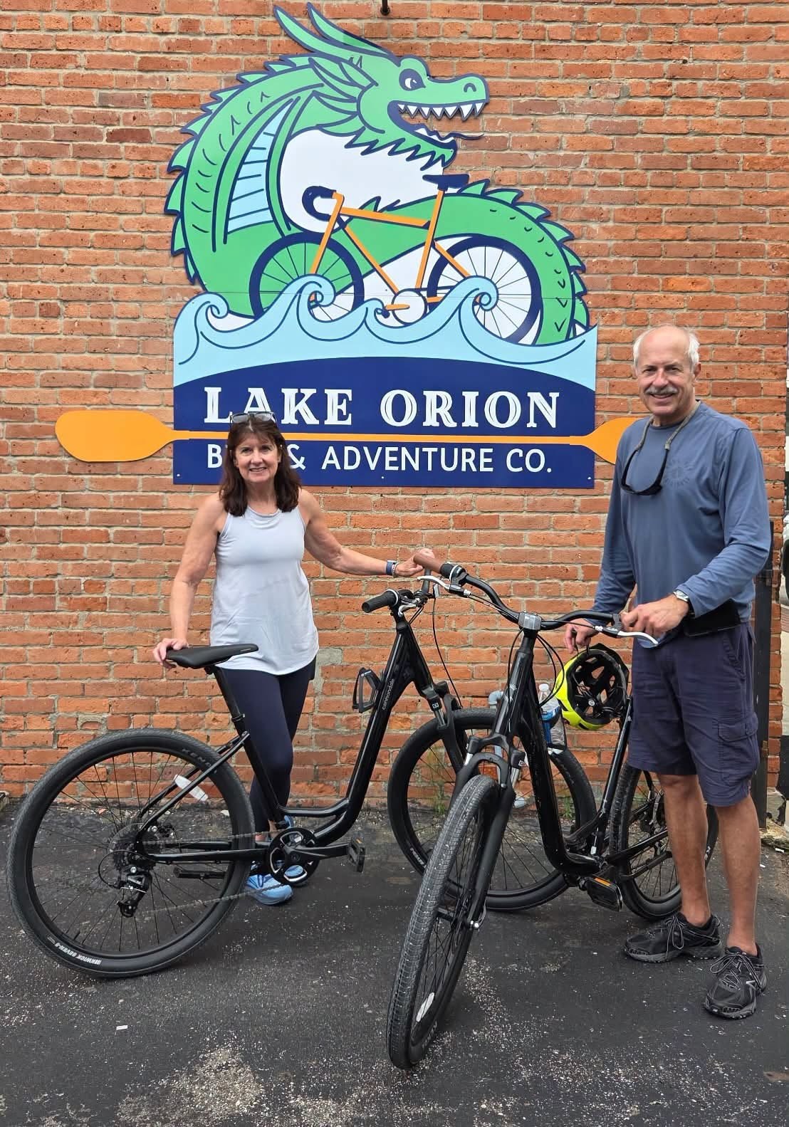 A couple with two e-bikes under the dragon sign