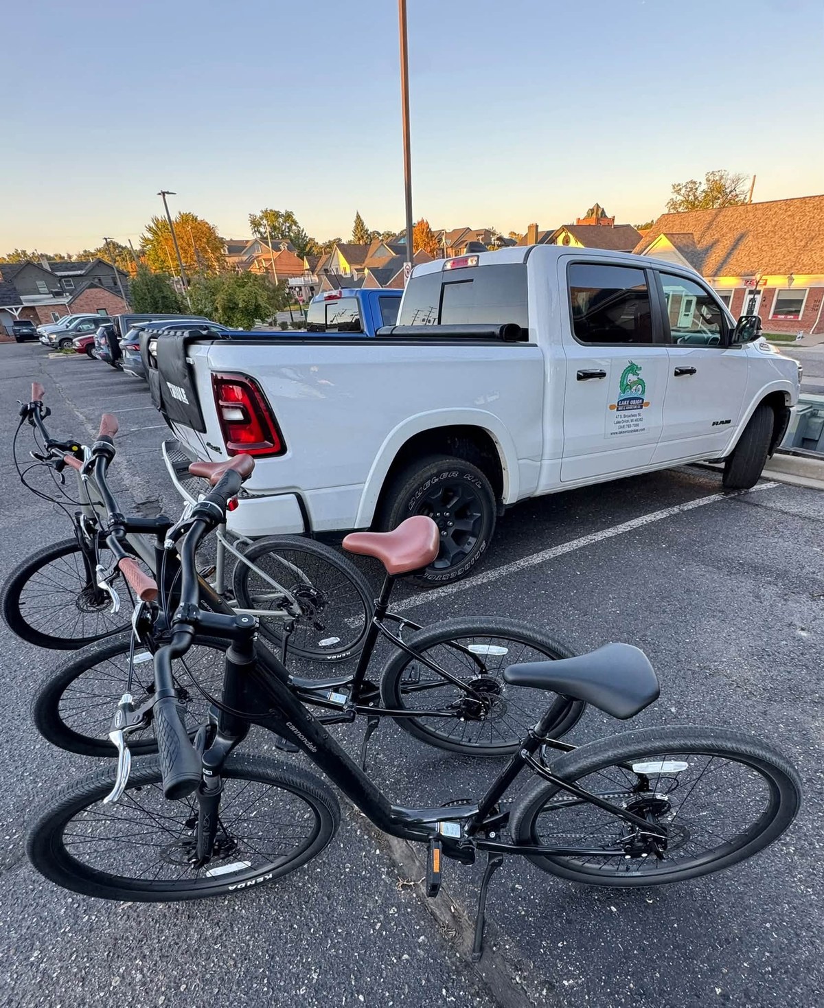 Bikes beside the shop's white pickup truck in a downtown lot