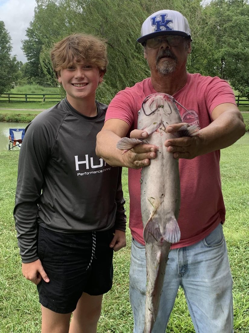 A young angler with a big catfish