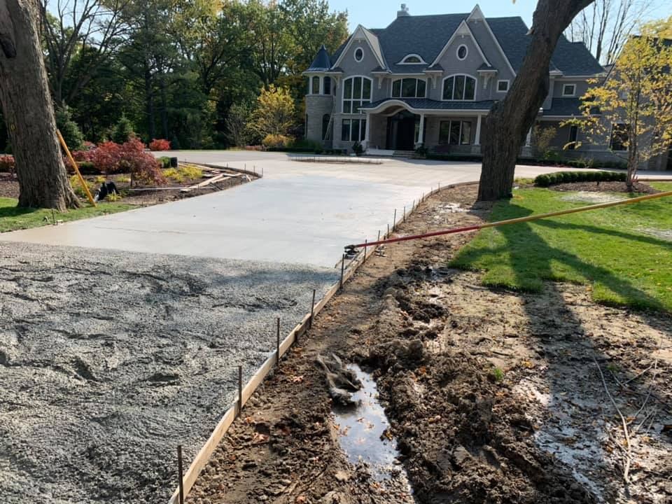 A freshly poured driveway and walk at a large home