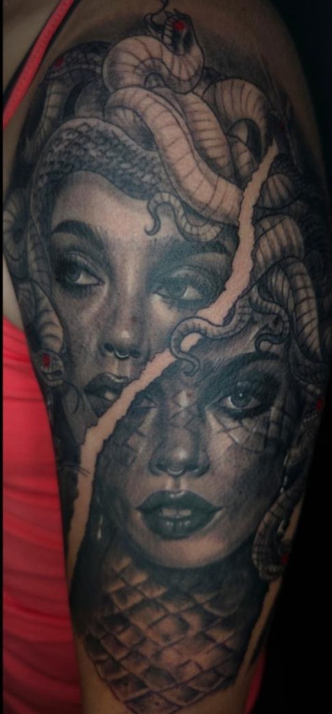 Black and grey Medusa portrait split into two faces with snakes and scalework