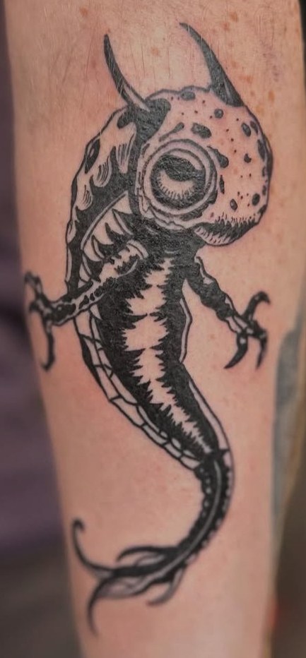 Blackwork horned creature with clawed limbs