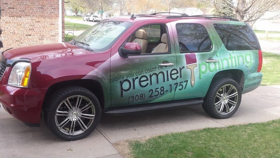 The wrapped Premier Painting Yukon parked outside a job