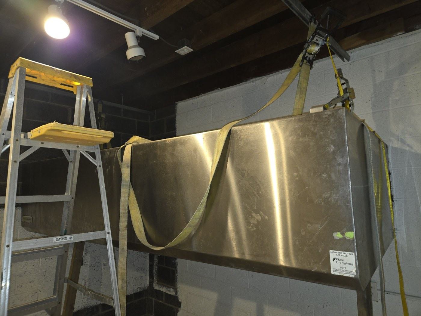 The commercial kitchen hood going in