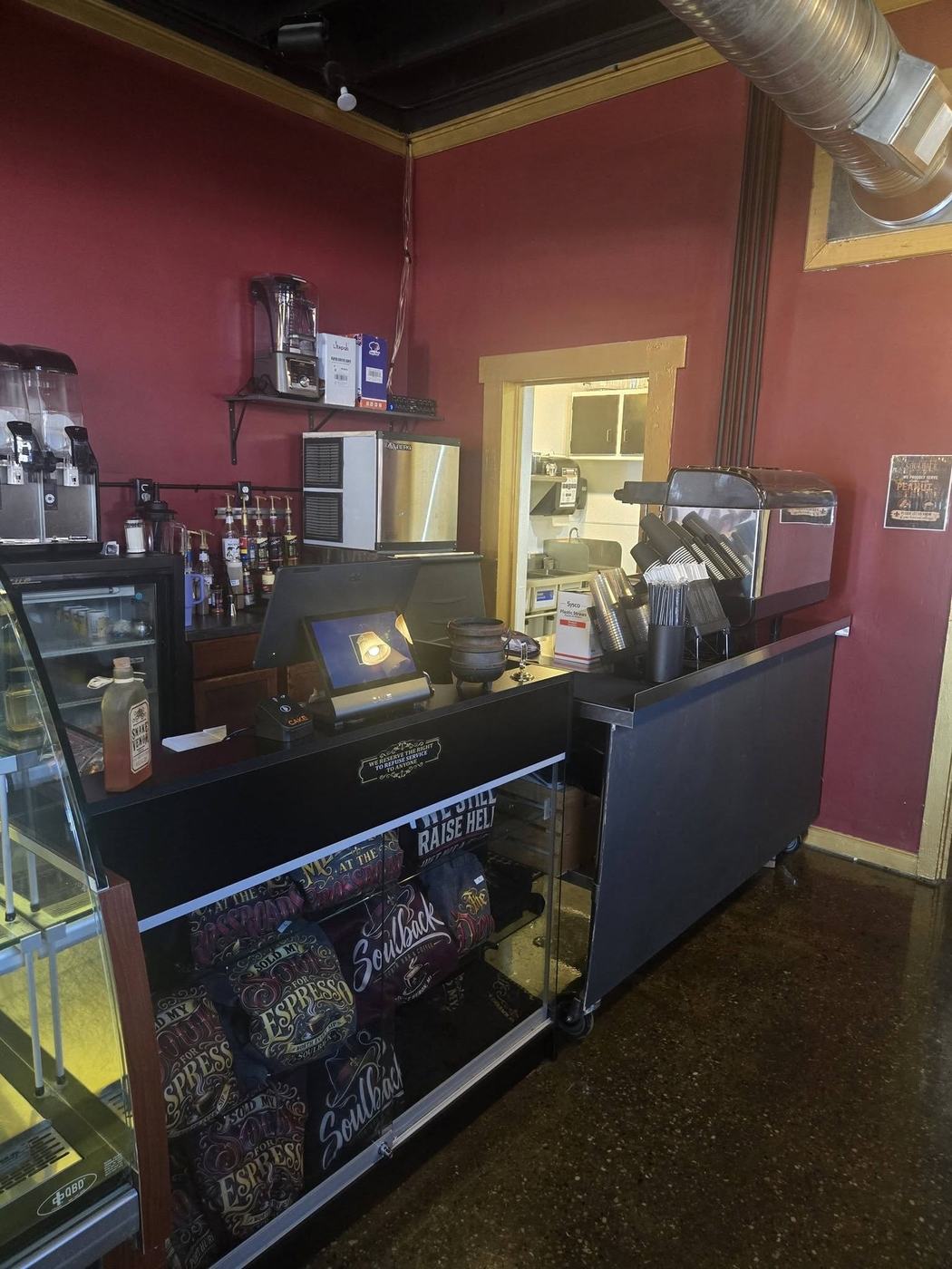 The Soulback counter and pastry case under wine-red walls