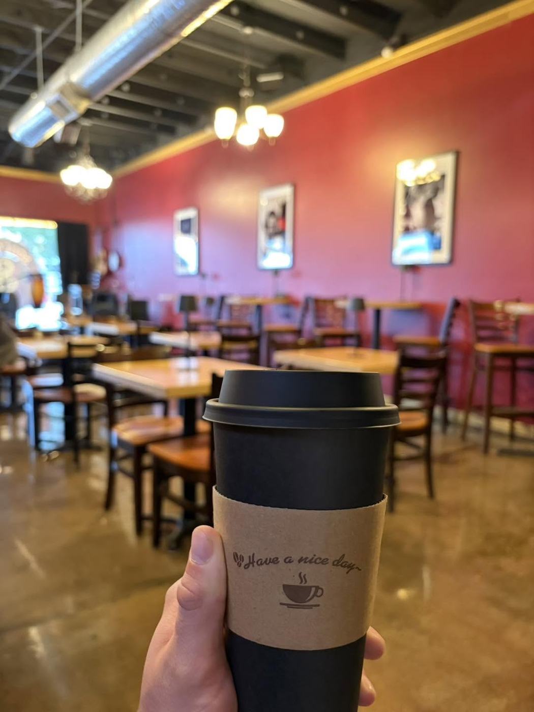 A Soulback to-go cup held up in the dining room
