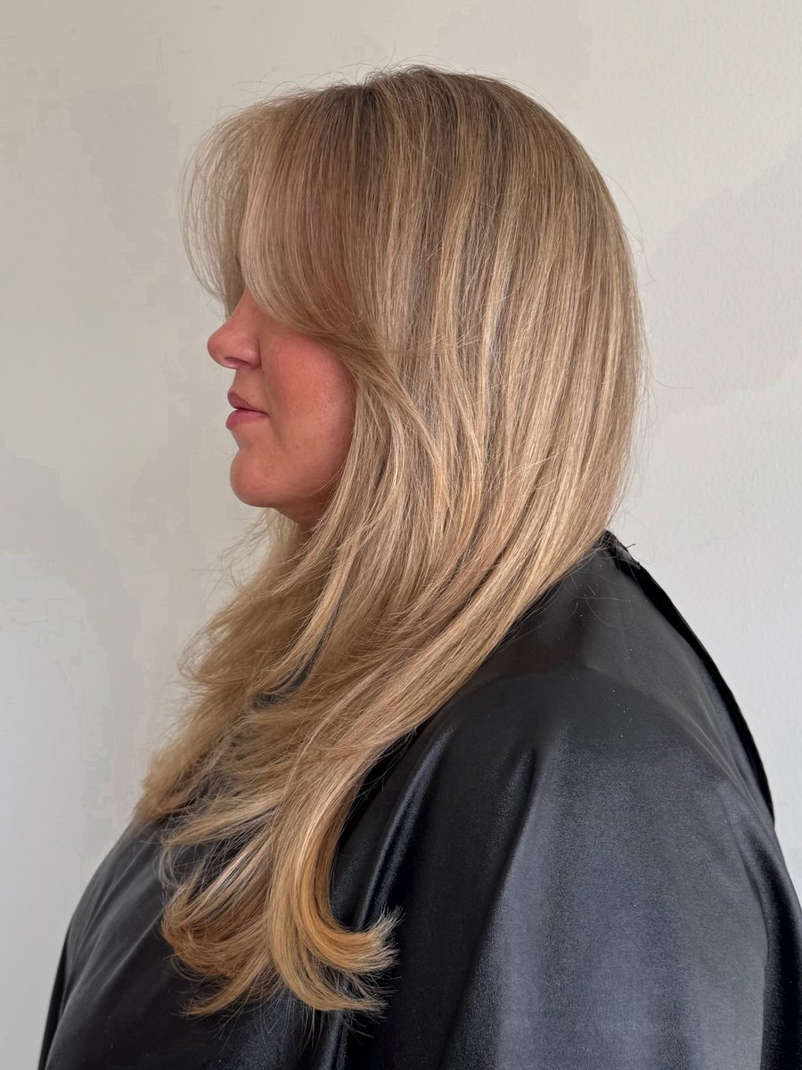 Soft blonde with curtain bangs, in profile