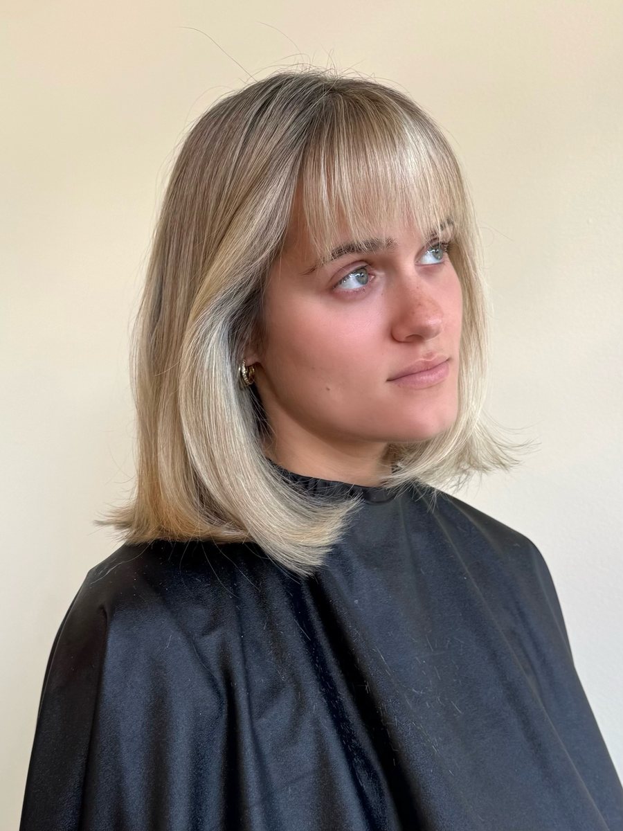 Blonde bob with a bright money piece and bangs