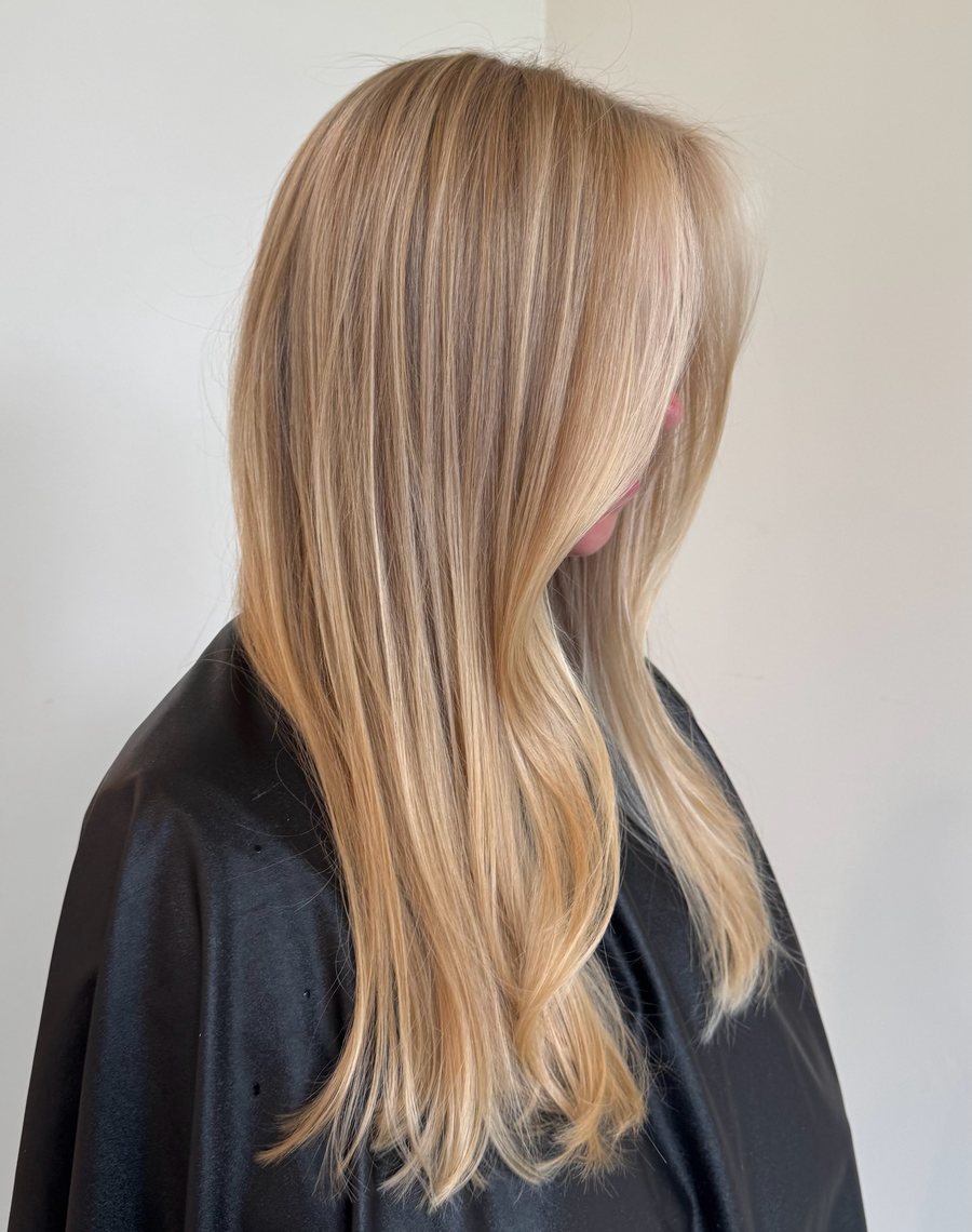 Sleek straight blonde, in profile