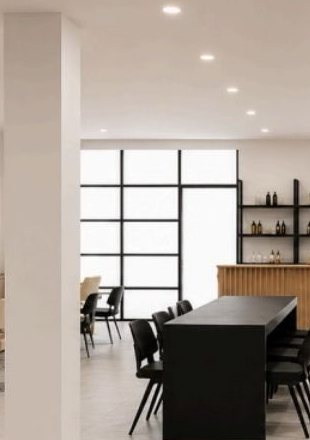 The lounge, with a long table and tall windows