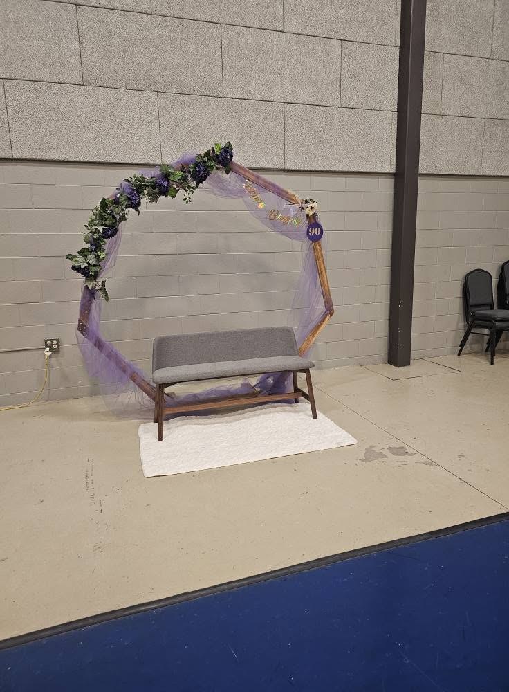 A floral arch set up in a reception hall