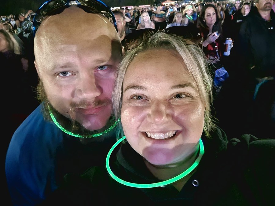 Crystal and Howard in glow necklaces at a concert